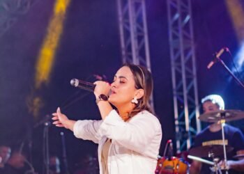 Female singer performing on stage with a microphone