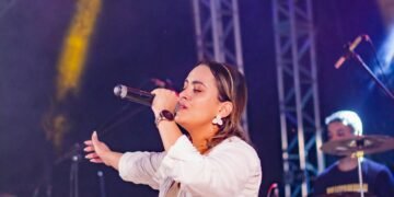 Female singer performing on stage with a microphone