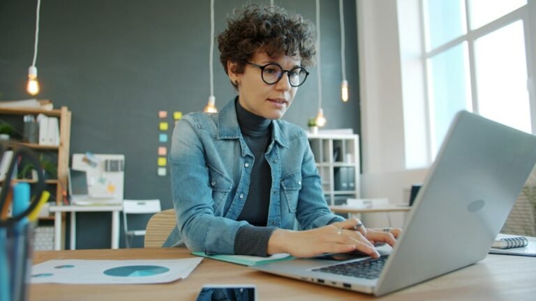 Professional working at a laptop in a modern office