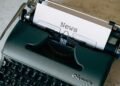 Typewriter in a newsroom setting, representing verification and journalism