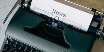 Typewriter in a newsroom setting, representing verification and journalism
