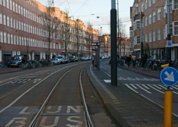 Tram line crossing a sunlit European city street