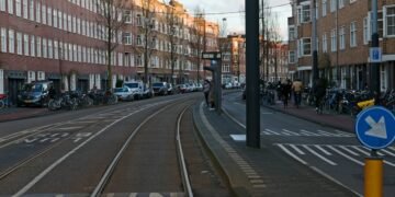 Tram line crossing a sunlit European city street